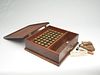 Vintage mahogany gunning box with 39 brass 12 gauge shells, bullet molds, and other tools.