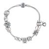 PANDORA - a charm bracelet. With eleven Pandora charms, including a fish and a gift box. . With make