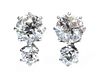A pair of two stone diamond stud earrings,