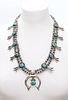 A silver Navajo turquoise squash blossom necklace,
