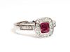 A platinum, ruby and diamond cushion shaped halo cluster ring,