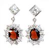 A pair of 18ct white gold garnet and diamond cluster drop earrings,