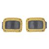 Two shoe buckles. Both designed as open gold-tone rectangles with textured detailing and black leath