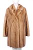 A three-quarter length pastel mink coat. Designed with a notched lapel collar, hook and eye clip fas