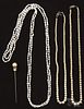 Three pearl necklaces, one faux, 18'' l., 20'' l., and 67'' l., together with a costume stick pin.