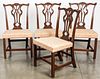 Four George III carved mahogany dining chairs