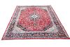 A FINELY WOVEN PERSIAN MASHAD CARPET, the red ground with t