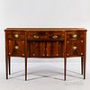 Federal Inlaid Mahogany Sideboard, New York, c. 1790, the top with serpentine front, stringing, and crossbanded edge, above a central d