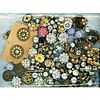 A HEAVY BAG LOT OF ASSORTED CLEAR AND COLORED PASTE JEWEL BUTTONS