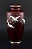 Ando Jubei, silver wired red ground cloisonne vase decorated with a flight of cranes, 21cm high,