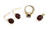 A 9ct gold garnet and diamond ring, pendant and earrings suite,