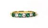 An 18ct gold emerald and diamond half eternity ring