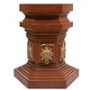 Pedestal. SXX. Elaborado en madera sólida. Con basal y capitel hexagonal. Con aplicaciones de latón dorado. 86 x 77 x 77 cm.