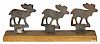 Three cast iron moose shooting gallery targets, early 20th c., on a stand, 7 1/2'' h., 18'' w.