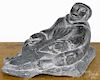 Inuit carved soapstone, 20th c., of an Eskimo and seal, 4 1/4'' h., 7'' w.