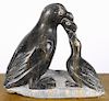Inuit carved soapstone penguin feeding young, signed Kevin Mann '78, 7'' h.
