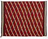 Navajo weaving with repeating diamonds on a red field with a triple border, 64'' x 50''.