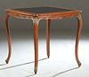 Louis XV Style Carved Mahogany Games Table, early 20th c., the stepped rounded edge bowed top with an inset gilt tooled black leather playing surface,