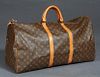 Louis Vuitton Keepall 60 Travel Bag, in a monogram coated canvas, with vachetta leather accents and golden brass hardware, opening to a brown canvas l