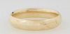 Lady's 14K Victorian Style Hinged Bangle Bracelet, 20th c., with leaf engraving, Int. H.- 2 in., W.- 2 1/4 in., Wt.- .71 Troy Oz.