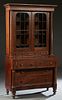 American Carved Mahogany Secretary Bookcase, 19th c., the ogee crown over double arched mullioned glazed doors, over two shallow drawers, flanked by t