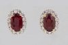 Pair of 18K Yellow Gold Stud Earrings, each with an oval ruby atop a border of tiny round diamonds, with screw posts, total ruby wt.- 2.15 cts, total 