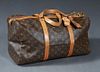 Louis Vuitton Sac Souple 45 Travel Bag, in a monogram coated canvas, with vachetta leather accents and golden brass hardware, in a brown canvas lined 