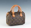 Louis Vuitton Mini Speedy Handbag, in a brown monogram coated canvas, with vachetta leather accents and golden brass hardware, with a brown canvas lin