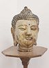 A cast and painted metal head of Buddha,