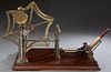 Spinner's Weasel, 19th c., by Goodbrand & Co., Ltd., Manchester, a yarn measuring device, on a mahogany base, said to be the origin of the children's 