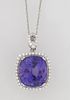 Platinum Pendant, with a 21.23 carat cushion cut tanzanite atop a conforming border of small round diamonds, with a pierced marquise shaped diamond mo
