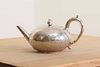 A Victorian silver teapot with ivory insulators,