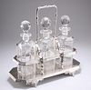 A LATE VICTORIAN SILVER-PLATED THREE-BOTTLE TANTALUS, with scroll feet and 