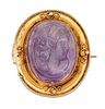 A 19TH CENTURY AMETHYST CAMEO BROOCH, the oval amethyst carved in relief de