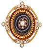 A VICTORIAN AGATE AND SPLIT PEARL BROOCH, a carved oval banded agate inset 
