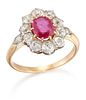 AN EARLY 20TH CENTURY RUBY AND DIAMOND CLUSTER RING, an oval-cut ruby withi