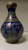 A blue ground famille rose onion topped bottle vase painted with mandarin ducks amongst lotus betwee
