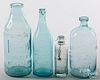 Four colorless glass bottles, 19th/20th c.