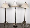 Pair of brass floor lamps and another lamp