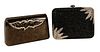 Two Judith Leiber Clutch Purses, hard side with magnetic jeweled flap, along with a jeweled black and silver bag, missing jewels.