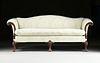 A GEORGE II STYLE UPHOLSTERED AND CARVED MAHOGANY SOFA,  