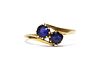 A gold two stone doublet crossover ring,