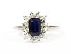 A white gold sapphire and diamond cluster ring,