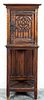 A Gothic Revival Carved Oak Cabinet. Height 50 1/4 x width 19 x depth 15 1/2 inches.