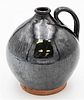 Redware Small Jug having handle and dark brown glaze small chip on foot height 6 1/4 inches