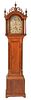 Timothy Barnes Cherry Tall Clock
having fret work top with three wood finials supported by fluted columns over long door flanked by fluted columns,
al