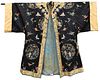 Chinese Silk Robe
dark blue ground, having embroidered panels of figures in a courtyard, butterflies and wild flowers