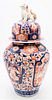 Large Japanese Imari Porcelain Jar
having foo dog finial on dome shaped cover on baluster form vase, painted with garden scenes
height 23 inches
Prove