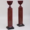 Pair of Italian Faux Porphyry Scagliola Columns with a Pair of Maroon Painted Urns