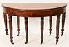 Sheraton Mahogany Demilune Table
opening to about 10 feet, supported by eight turned legs ending in brass casters, along with two 20 inch leaves
circa